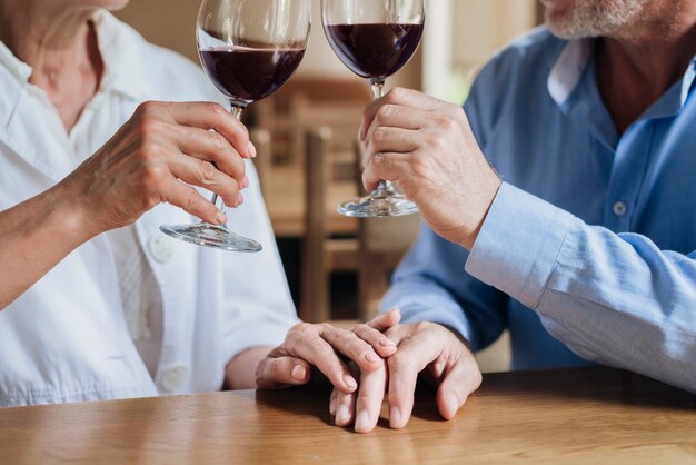 Close-up couple making a toast at restaurant