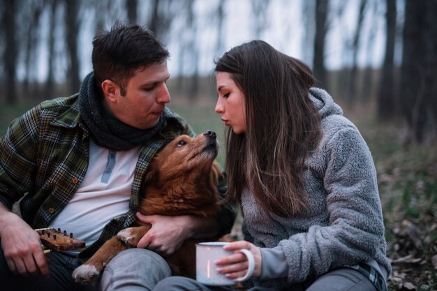 Close-up couple playing with dog