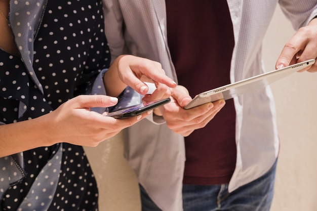 Close-up of a couple pointing at something on digital tablet