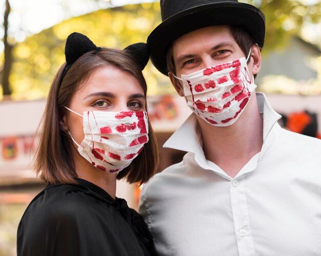 Close-up couple posing with masks