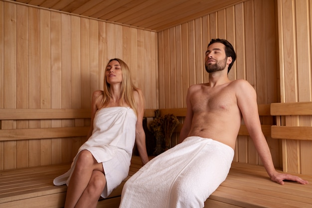 Close up on couple relaxing in the sauna