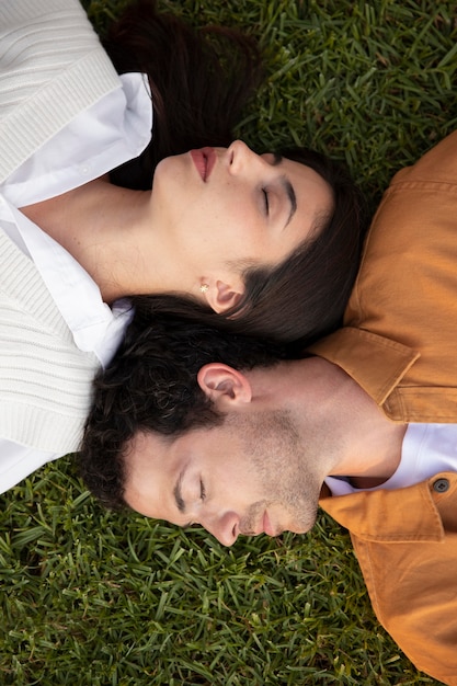 草の上で寝ているカップルをクローズアップ