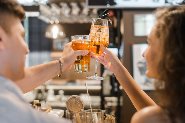 Close-up of a couple toasting drinks