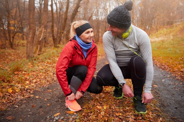 Close up of couple tying shoelaces