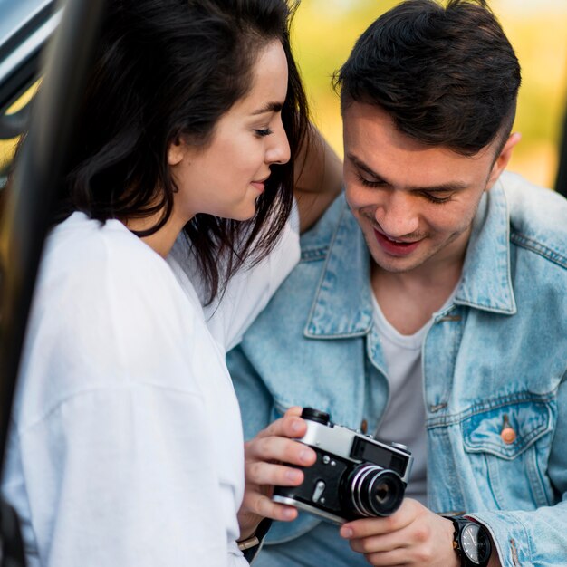 Close-up couple using a retro camera