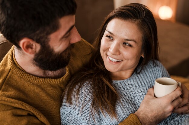 Close-up couple with coffee cup