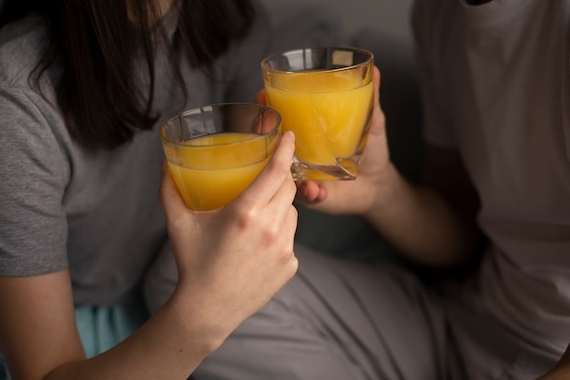 Close-up of couple with orange juice