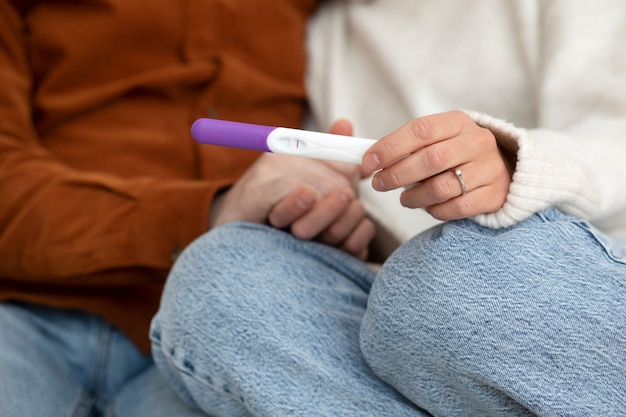 Close up couple with pregnancy test