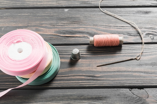 Close-up of craft sewing equipment with rolled ribbons