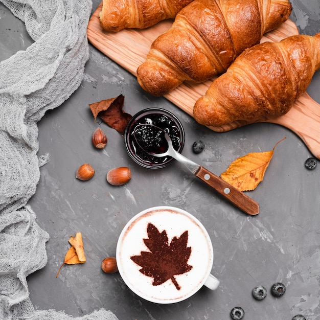 Close-up of croissants, jam and coffee