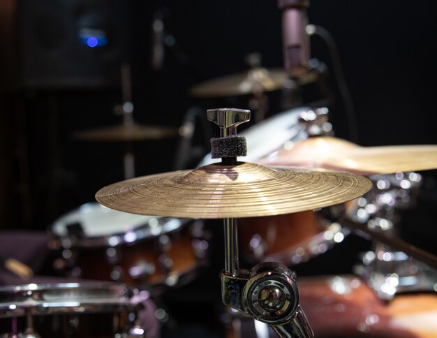 Close up cropped image of drum kit with cymbal on a blurred background.