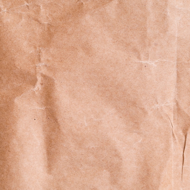 Free photo close-up crumpled paper background