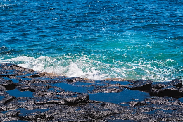 Close-up crystalline wavy water at the beach