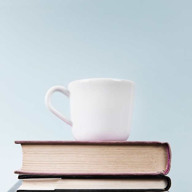 Close-up of cup and books with copy space