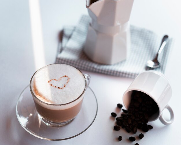 Close-up cup of coffee latte with kettle