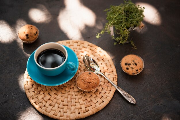 Close-up cup of coffee with muffins