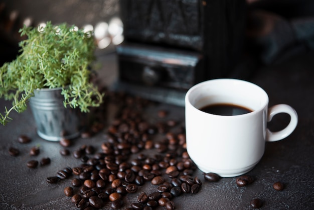 Close-up cup of coffee with roasted beans