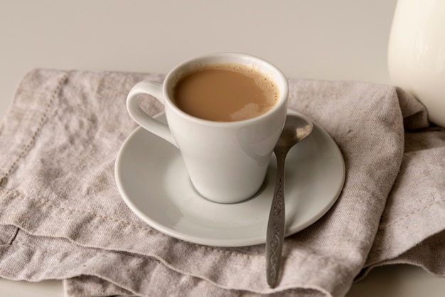 Close-up cup of milk coffee on a plate