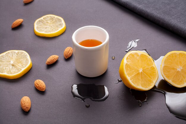 Close-up cup of tea surrounded by lemon slices