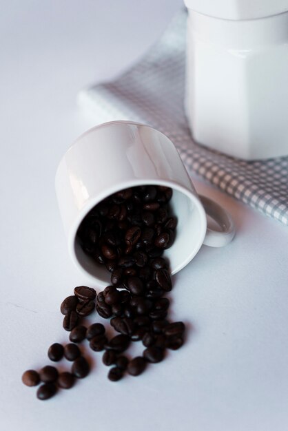 Close-up cup with roasted coffee beans