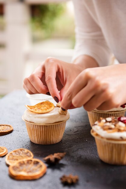 Close-up of cupcake with icing and dried citrus