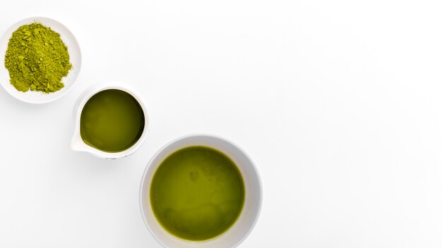 Close-up cups with matcha powder on the table