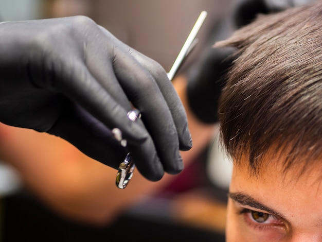 Close-up of customer and scissors