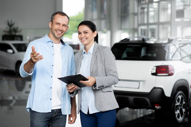 Close up on customer with business person in car dealership