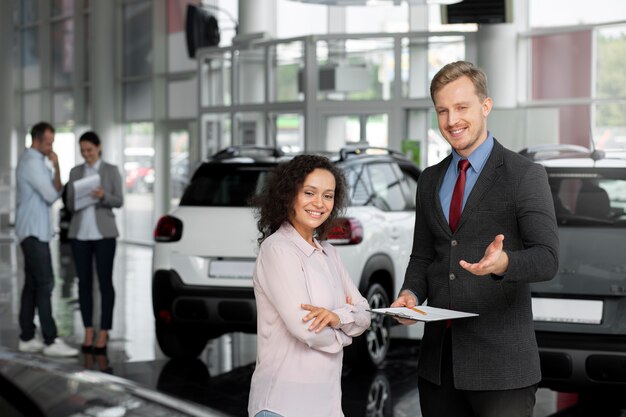 Close up on customer with business person in car dealership