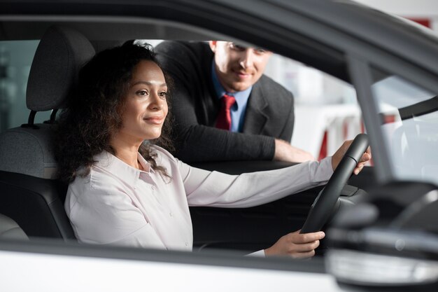 Close up on customer with business person in car dealership