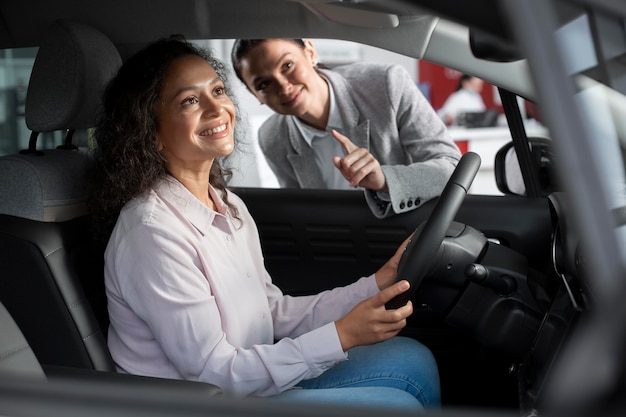 Close up on customer with business person in car dealership