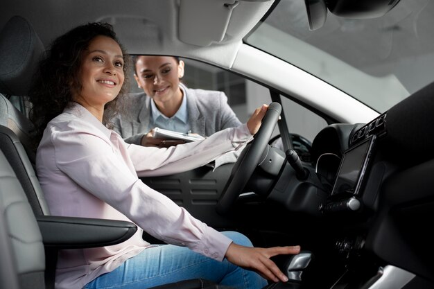 Close up on customer with business person in car dealership