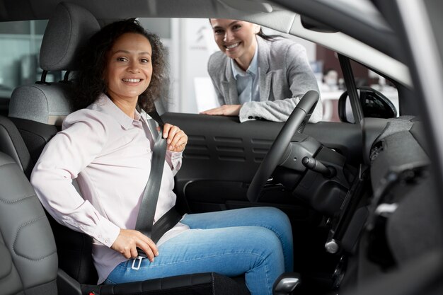 Close up on customer with business person in car dealership