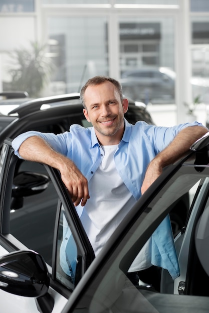 Close up on customer with business person in car dealership