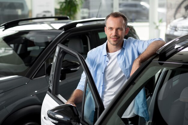 Close up on customer with business person in car dealership