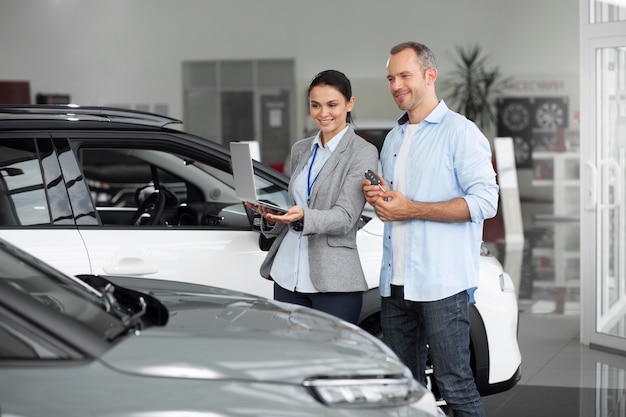 Close up on customer with business person in car dealership