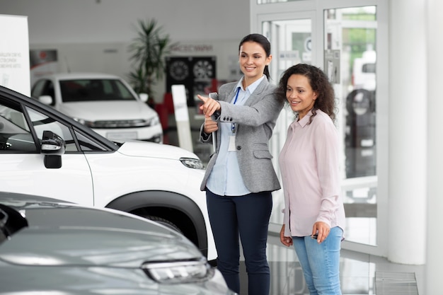 Close up on customer with business person in car dealership