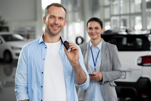 Close up on customer with business person in car dealership