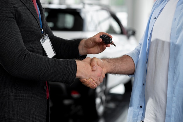 Close up on customer with business person in car dealership