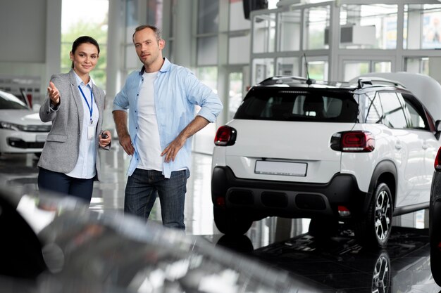 Close up on customer with business person in car dealership