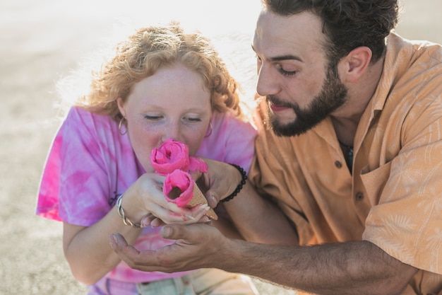 Free photo close-up cute couple with pink ice cream