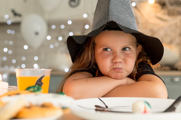 Primo piano della bambina sveglia con il costume della strega