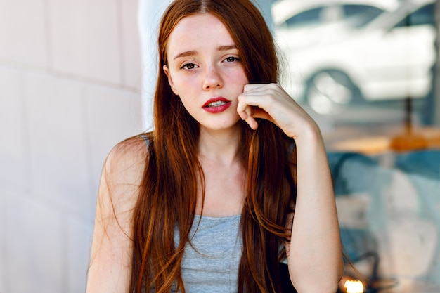 Close up cute portrait of pretty redhead woman , with amazing long hairs, fresh natural make up, big smile and eyes, pastel soft colors, tender sensual mood.