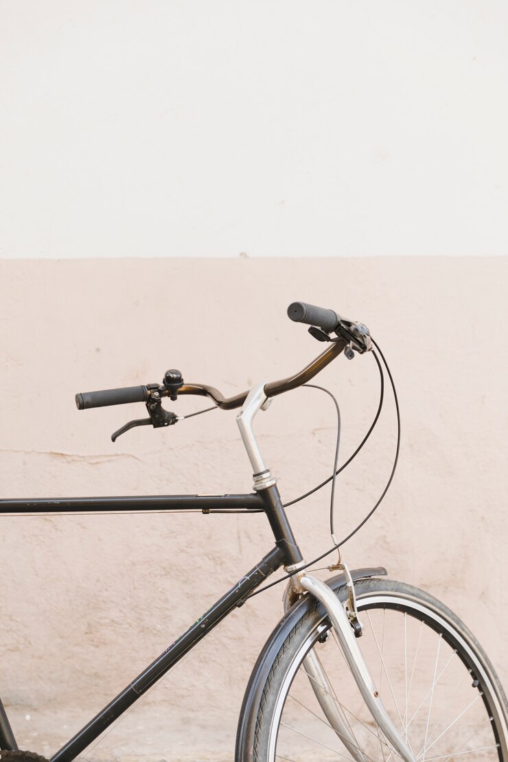 Free Photo close-up of a cycle's handle in front of dual color wall