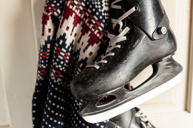 Close-up decoration with ice skates and sweater hanging on the door