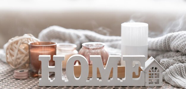 Close up decorative word home on blurred background with candles