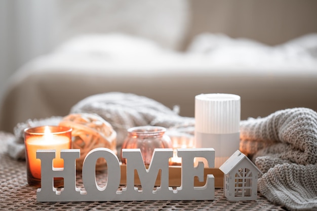 Close up decorative word home on blurred background with candles