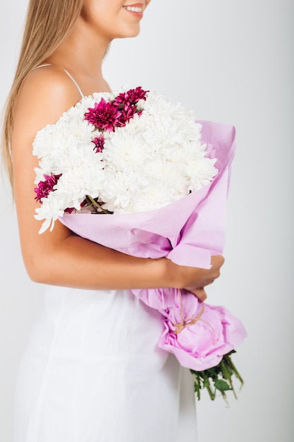 Close-up delicate woman hands holding bunch of flowers