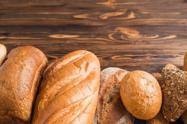 Close-up of delicious baked breads on wooden surface