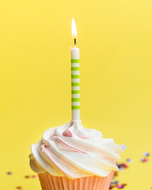 Close-up delicious birthday muffin and candle